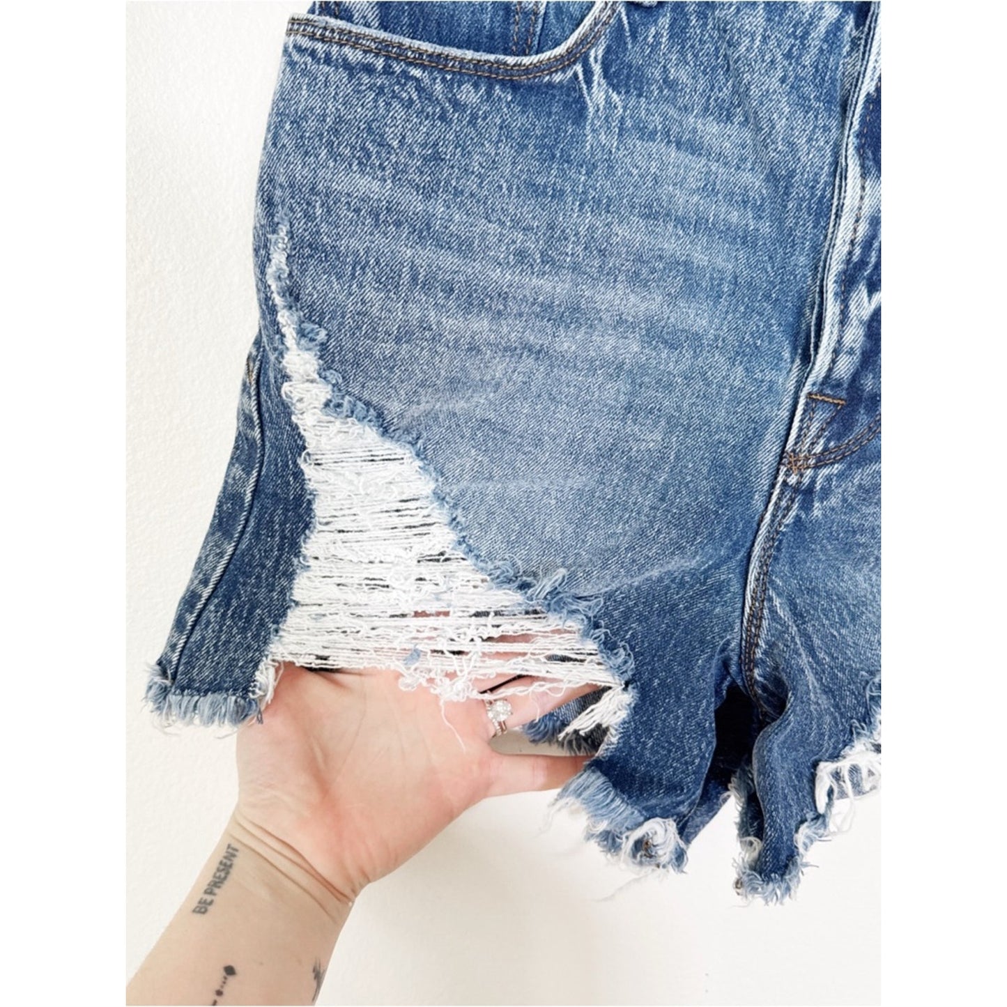 Good American Medium Blue Denim Shorts with Distressed Detailing 4/27