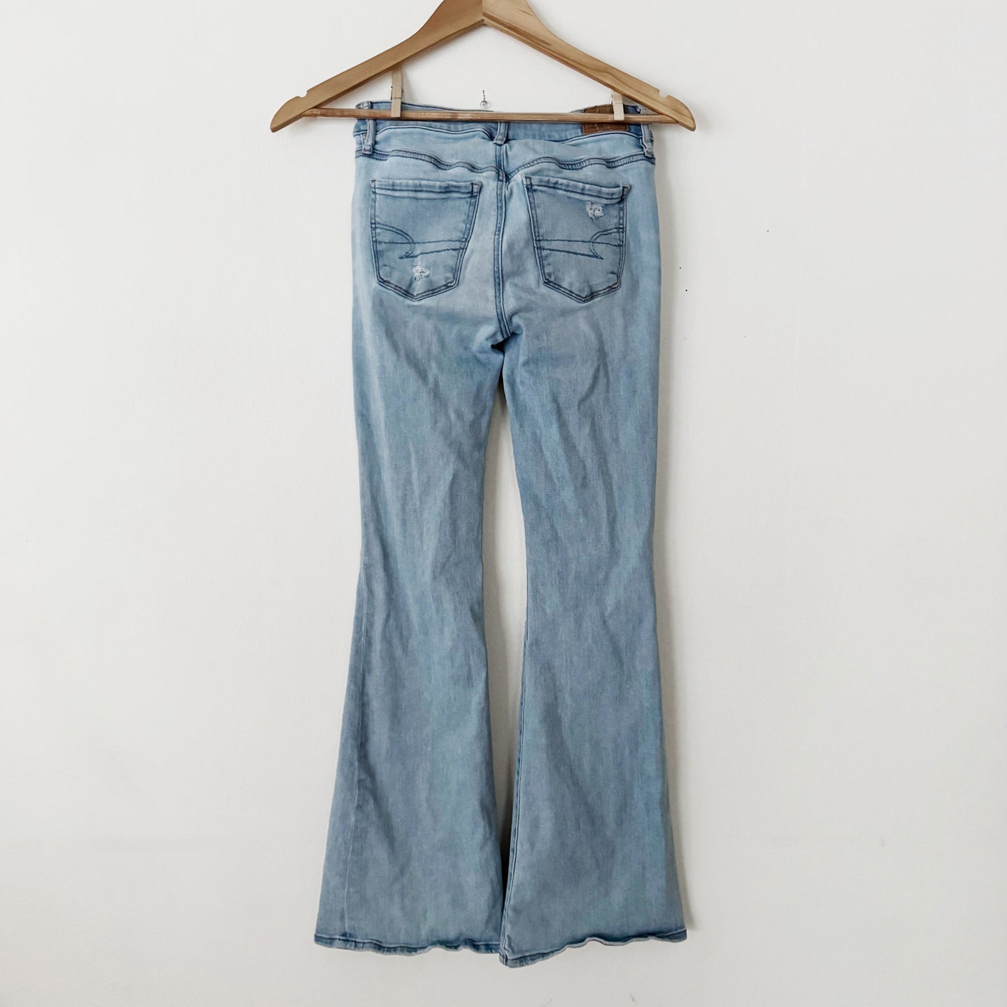 0 | American Eagle Light wash flares knee ripped jeans